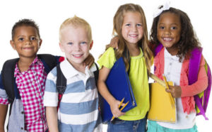 four children with school backpacks