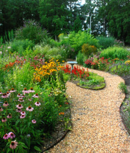 curved pathway through a flower garden in bloom