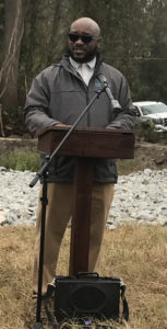 man speaking at an outdoor podium
